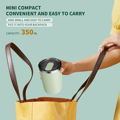 Person holding a green travel mug with a brown strap, placed inside a yellow bag on a light blue background.